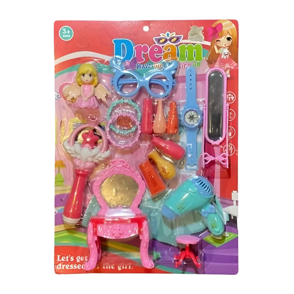 Dream beauty playset in blister packaging with doll, toy hairdryer, glasses, watch, vanity table, and colorful accessories on a bright pink background.