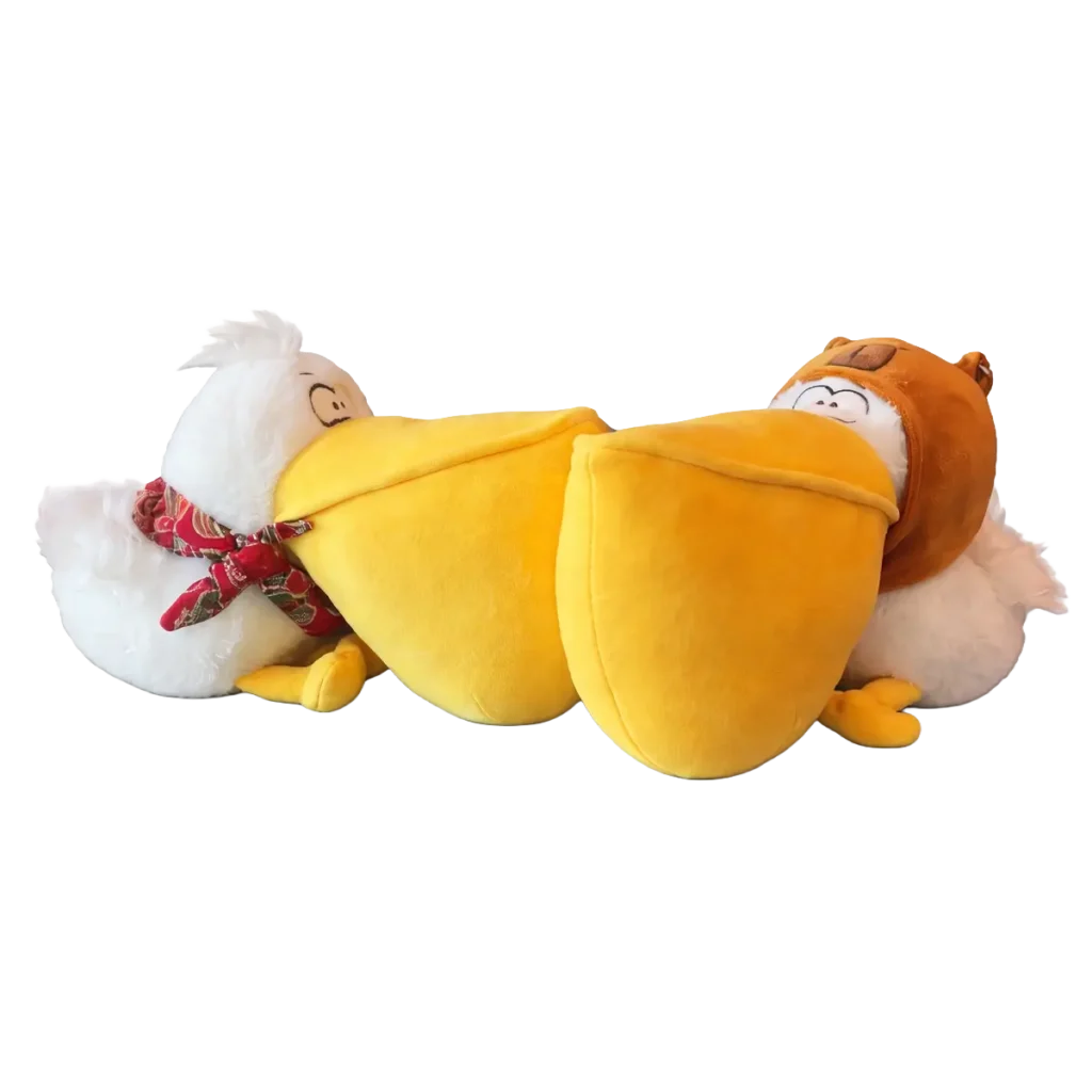 Two plush pelican toys with oversized yellow beaks, one with a red bandana and one with a brown cap, facing each other on a white background.