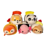 Assorted cute plush animals in food-themed costumes including a fox, panda, penguin, axolotl, and deer, arranged together on a white background.