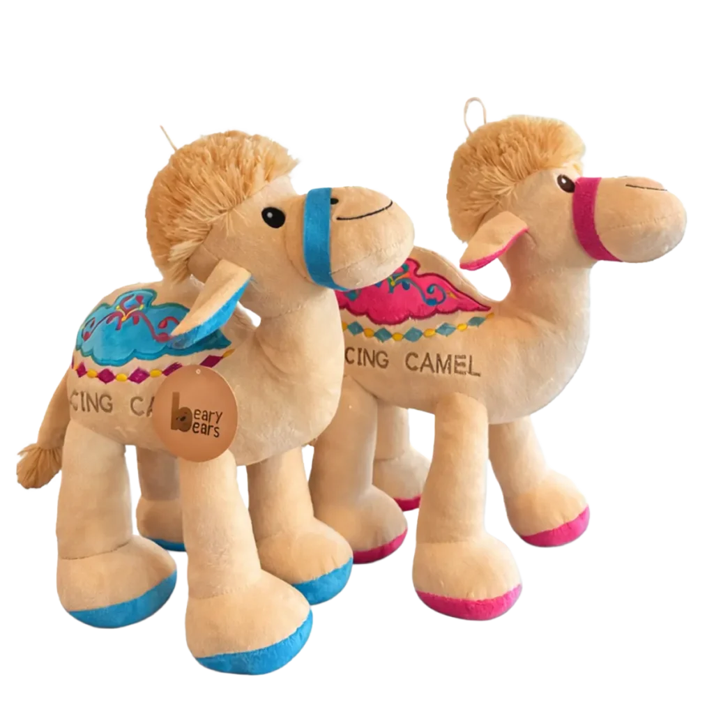 Two plush camel toys with colourful saddles and halters, shown side by side on a white background.