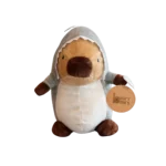 Plush capybara toy wearing a grey shark costume with hood, shown on a white background.
