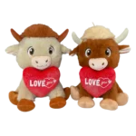 Two plush cows with red hearts “LOVE you”, one beige and one brown, sitting next to each other.