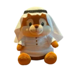 Plush bear in white traditional Arabic outfit with headscarf, sitting against a white background.
