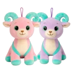 Pink and purple plush goat with turquoise horns and backpack, sitting next to each other.