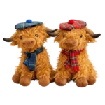 Two plush Scottish Highlanders wearing tartan hats and scarves in blue and red, sitting next to each other against a white background.