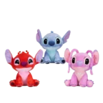 Three Disney Stitch plush toys in red, blue, and pink variants, sitting upright with large ears and big eyes, displayed on a white background.