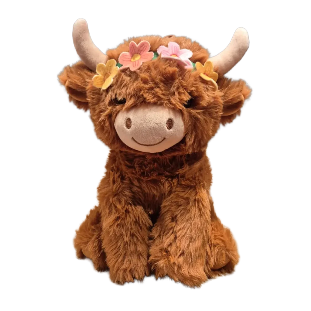 Brown Highland cow plush with long soft fur, cream horns, and a colorful flower crown on its head