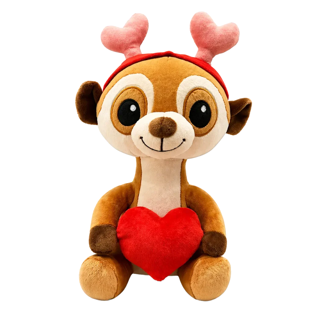 Cute plush meerkat holding a red heart, with pink antlers and a red headband, isolated on a clean white background.