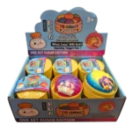 Display box with colorful squishy dumpling mystery toys in yellow containers, featuring rainbow surprise packaging and anime-style designs.