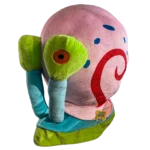 Large plush snail inspired by a popular cartoon character, featuring a soft pink shell with blue spots and a red swirl pattern. The snail has bright green eye stalks, a blue body, and embroidered details, sitting upright against a white background.